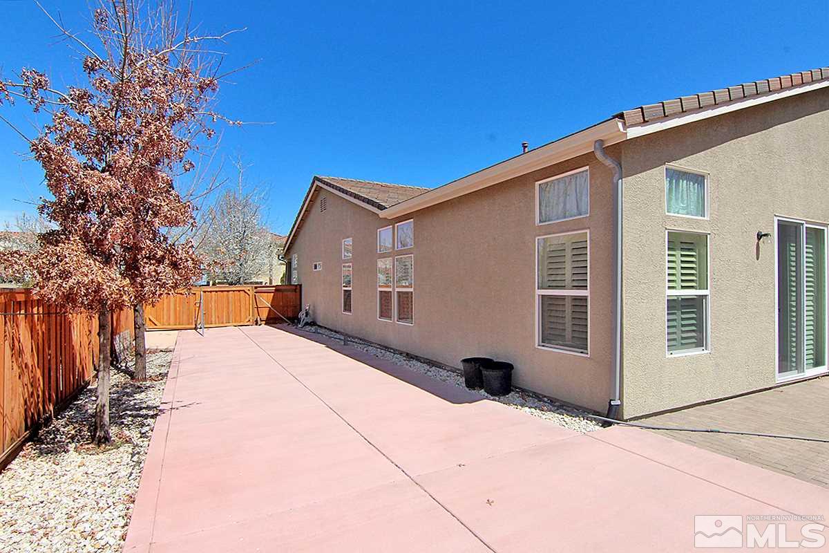 450 Manciano Way Reno, NV 89521 - Photo 35 of 39 a view of a house with backyard and trees