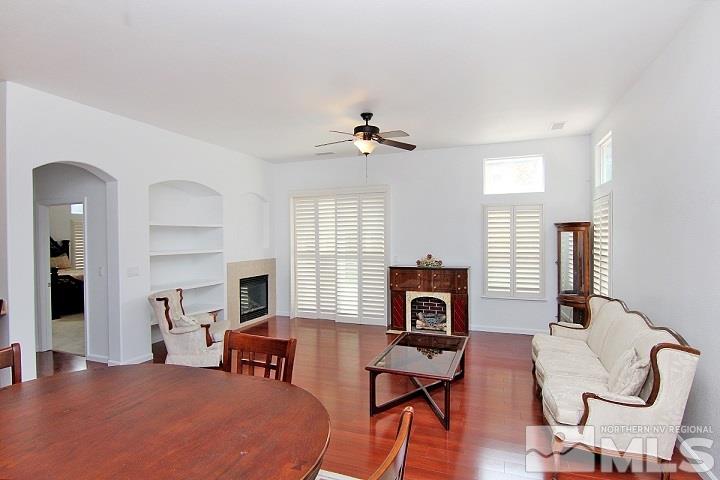 450 Manciano Way Reno, NV 89521 - Photo 5 of 39 a bedroom with furniture a window and a fireplace
