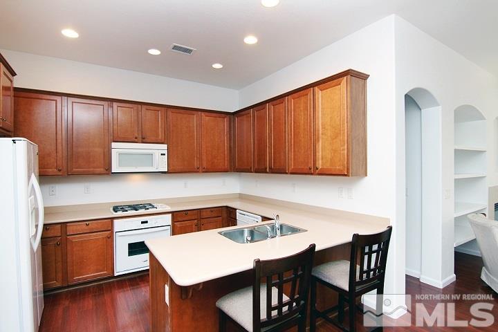 450 Manciano Way Reno, NV 89521 - Photo 9 of 39 a kitchen with a wooden table and chairs