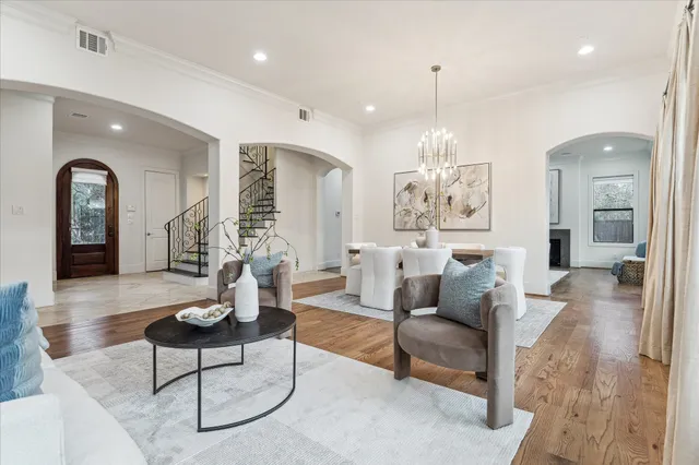 a living room with furniture and a chandelier