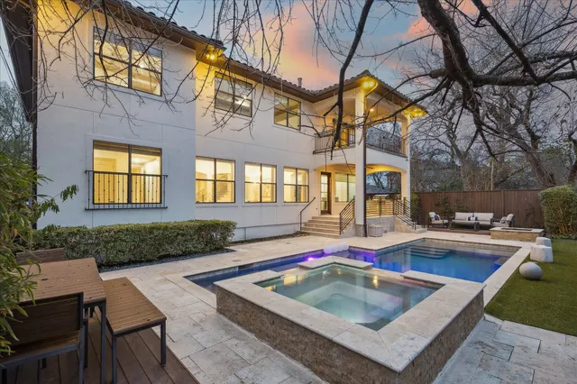 a view of a house with backyard swimming pool and sitting area