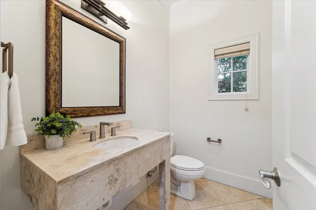 a bathroom with a toilet a sink and mirror