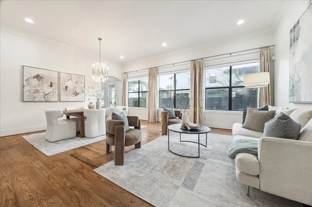 a living room with furniture and large windows