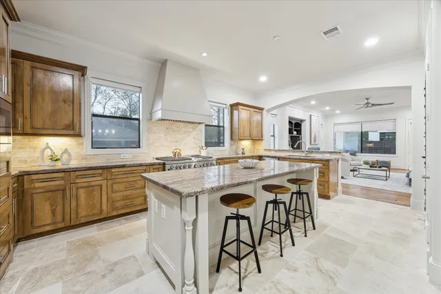 a large kitchen with kitchen island a large counter space and appliances
