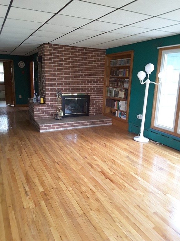 40 Anderson Road Ware, MA 01082 - Photo 11 of 19 a view of empty room with wooden floor and fireplace
