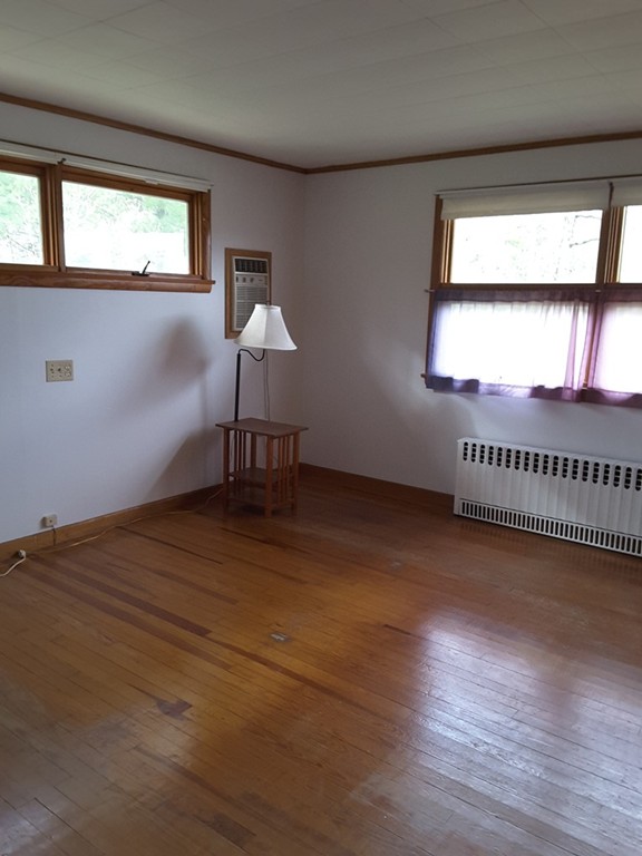 40 Anderson Road Ware, MA 01082 - Photo 13 of 19 an empty room with wooden floor and windows