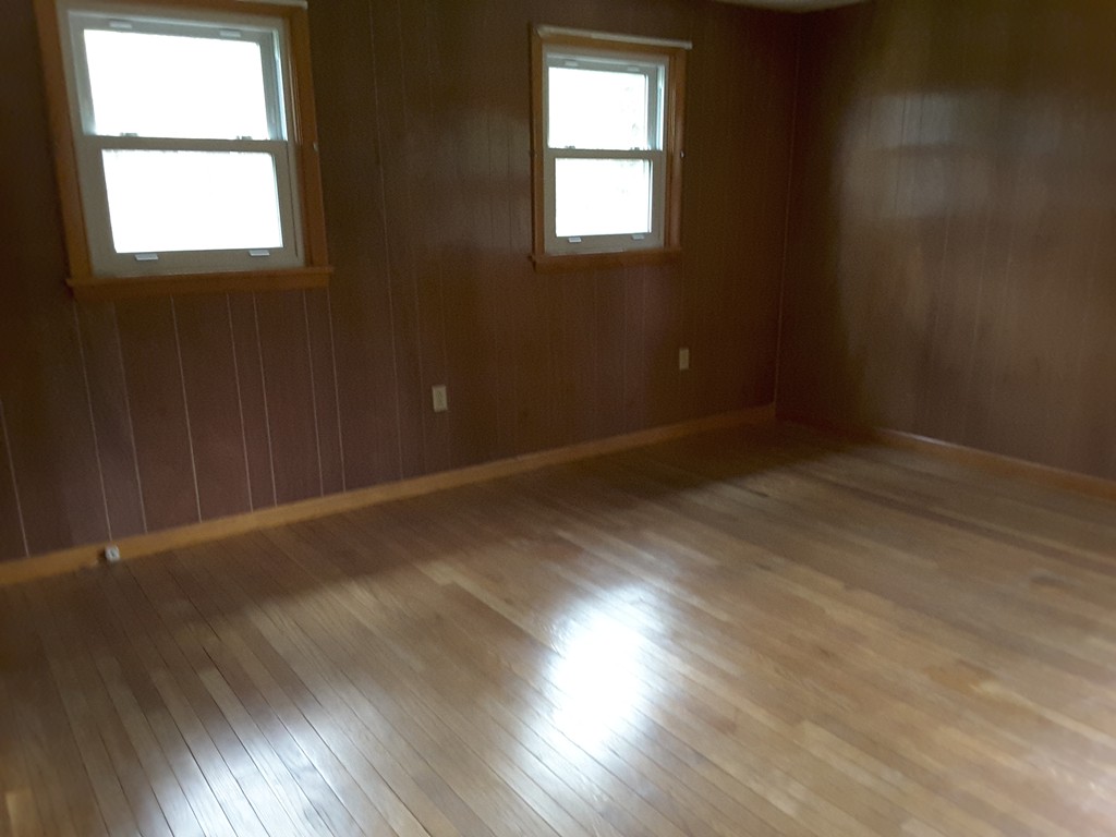 40 Anderson Road Ware, MA 01082 - Photo 16 of 19 an empty room with wooden floor and windows