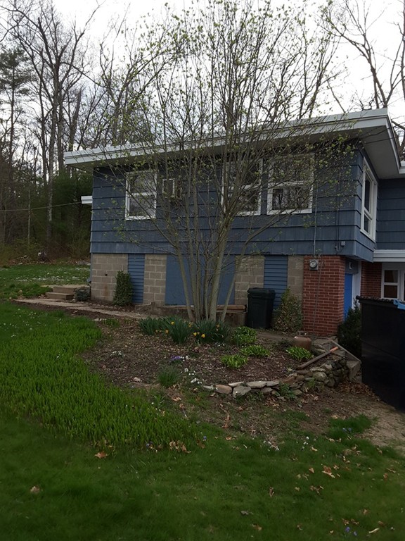 40 Anderson Road Ware, MA 01082 - Photo 3 of 19 a backyard of a house with dishwasher and wooden fence