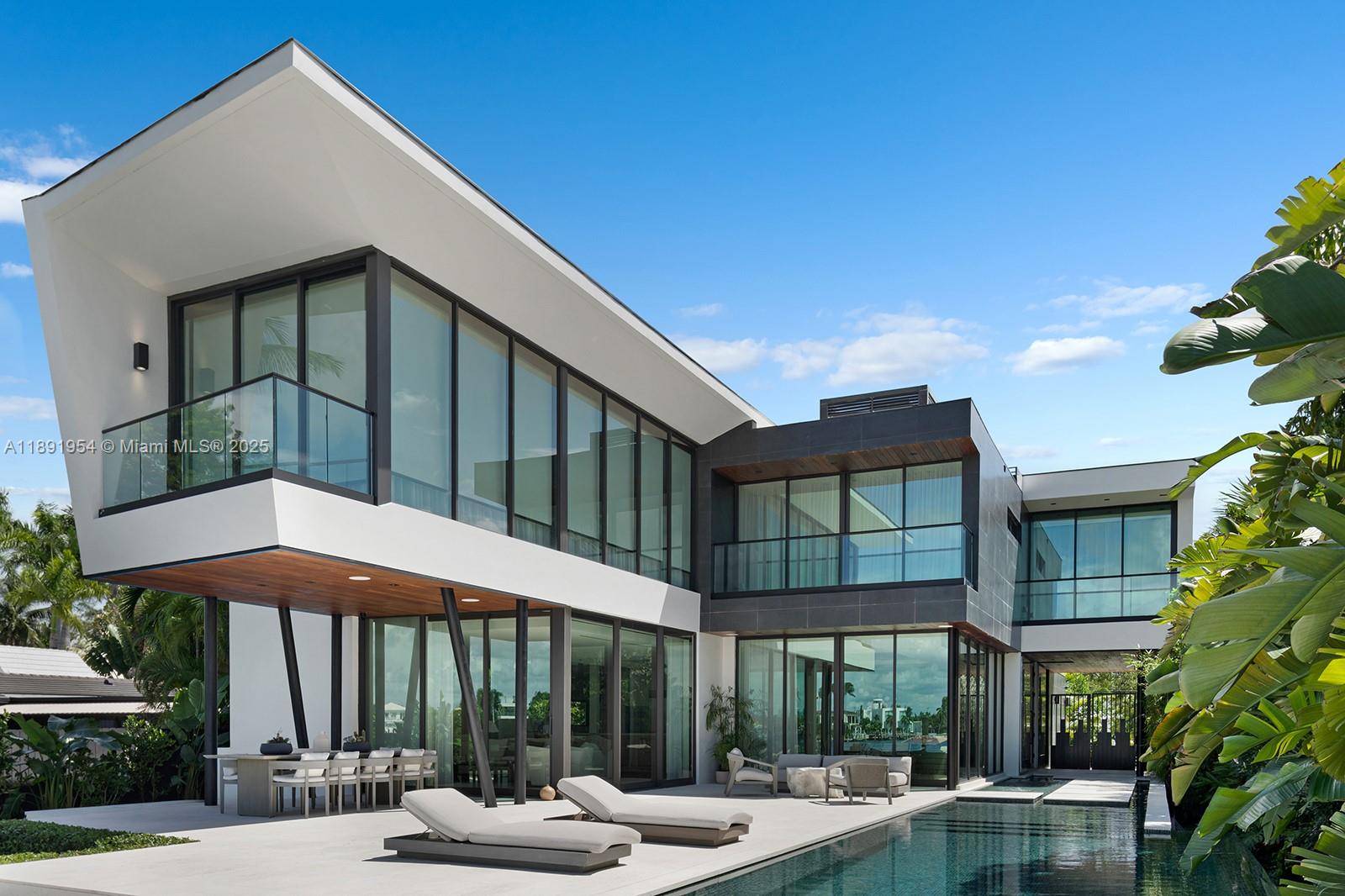 1155-1165 North Biscayne Point Road Miami Beach, FL 33141 - Photo 28 of 35 a patio with a table and chairs under an umbrella