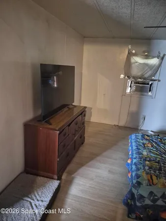 a white toilet sitting next to a shower