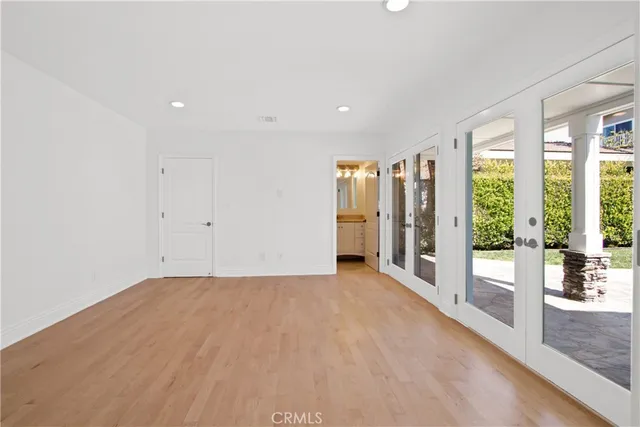 a view of an empty room with glass door