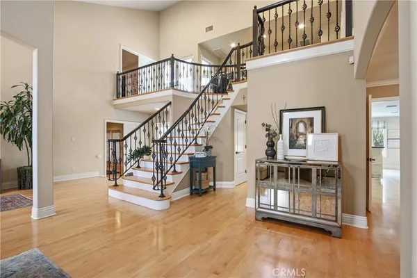 a view of entryway and hall with wooden floor