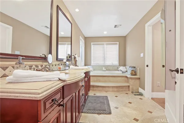 a spacious bathroom with a bathtub and a sink