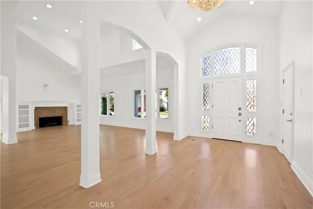 a view of a big room with wooden floor and windows