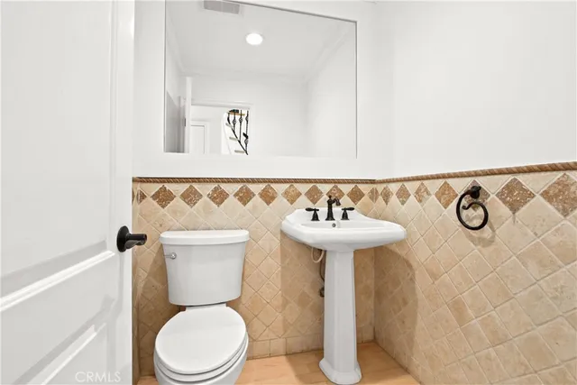 a bathroom with a sink mirror and toilet