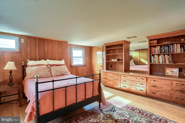 a bedroom with furniture and a book shelf