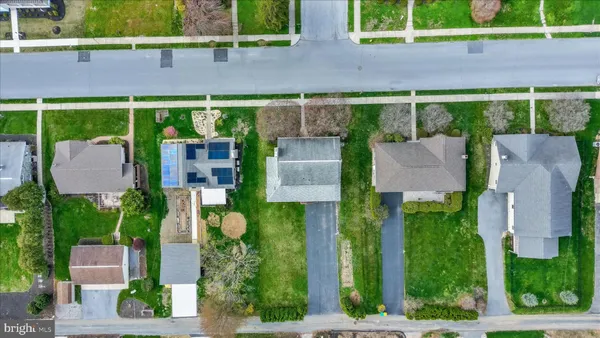 an aerial view of a house with garden space and street view