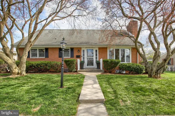 a front view of a house with yard and green space