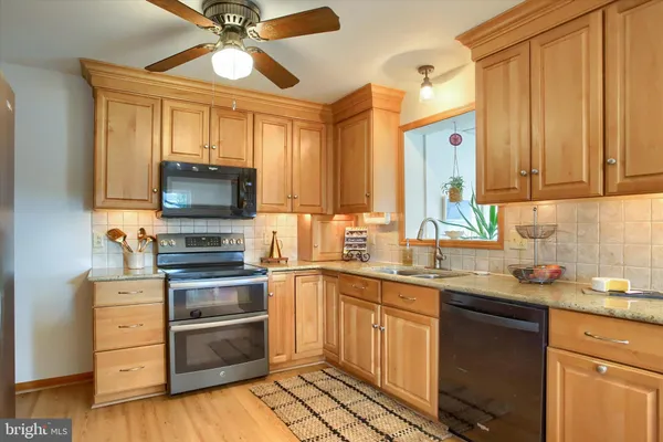 a kitchen with a sink stove and microwave