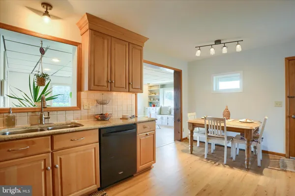 a kitchen with a table chairs sink and cabinets