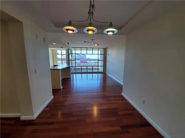 a view of a room with wooden floor