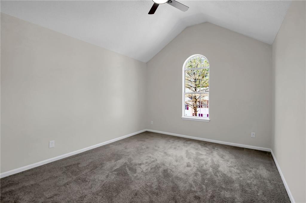 6566 Shaffers Way Lithonia, GA 30058 - Photo 21 of 31 an empty room with windows and fan