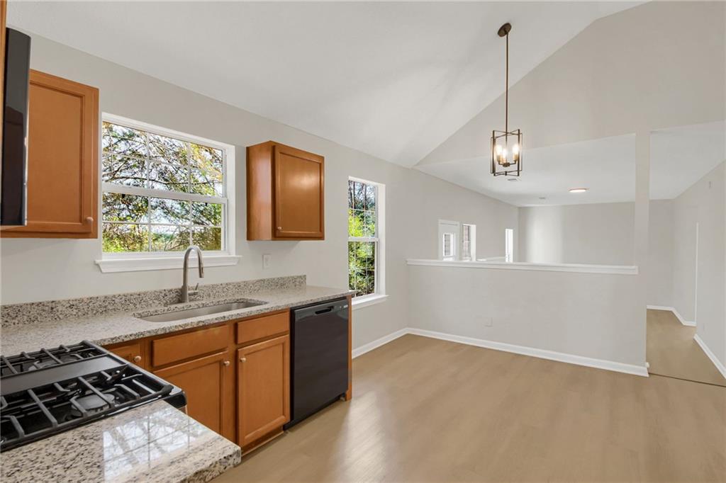 6566 Shaffers Way Lithonia, GA 30058 - Photo 6 of 31 a kitchen with stainless steel appliances granite countertop a sink stove and refrigerator