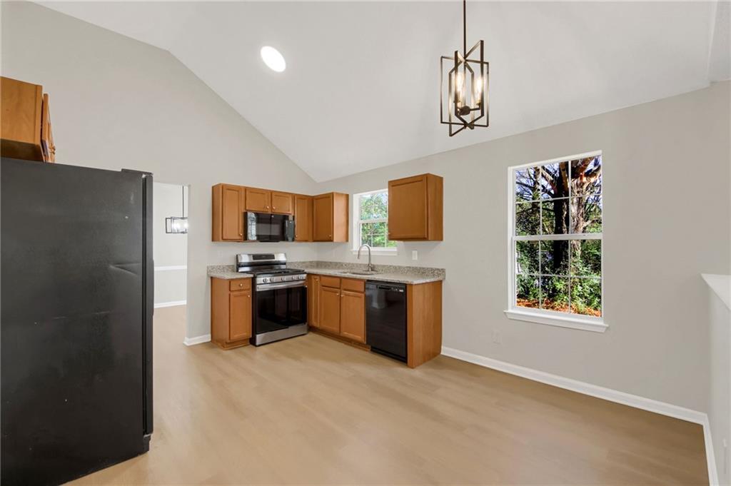 6566 Shaffers Way Lithonia, GA 30058 - Photo 10 of 31 a large kitchen with a stove a sink and a refrigerator