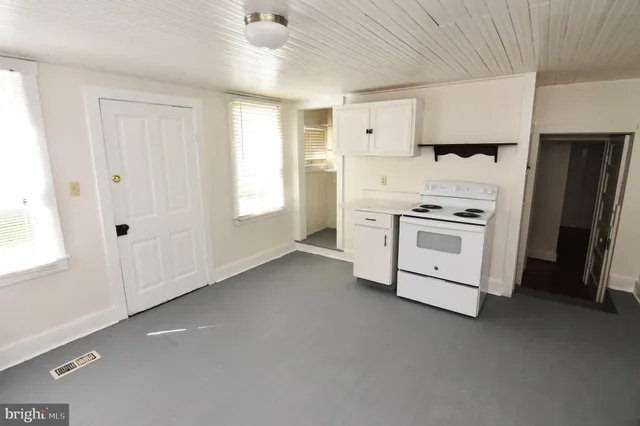 a kitchen with cabinets appliances and a window