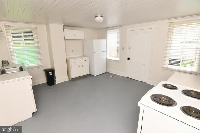a view of kitchen with furniture and window