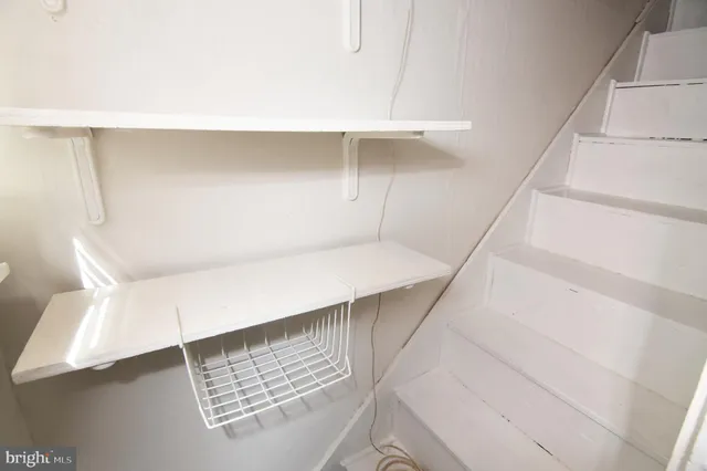 a view of staircase with white walls and a window