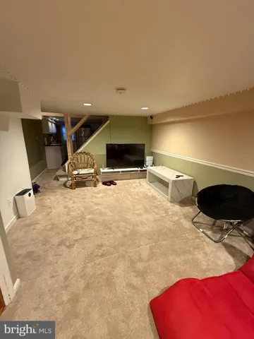 a room with gym equipment and a view of living room