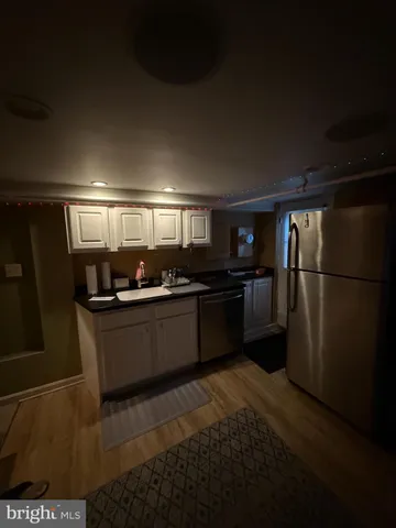 a large kitchen with lots of counter top space and stainless steel appliances