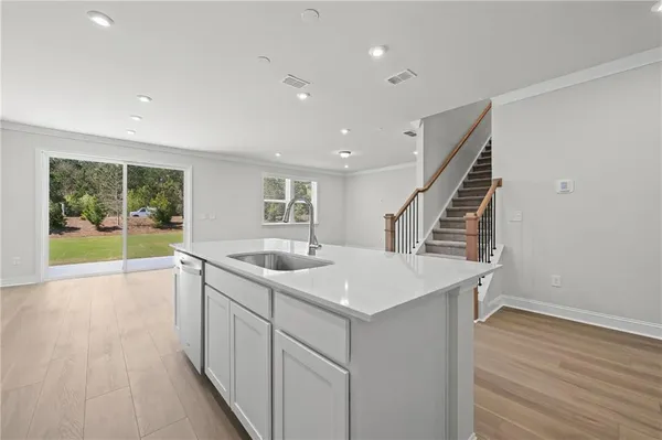 a kitchen with sink and mirror