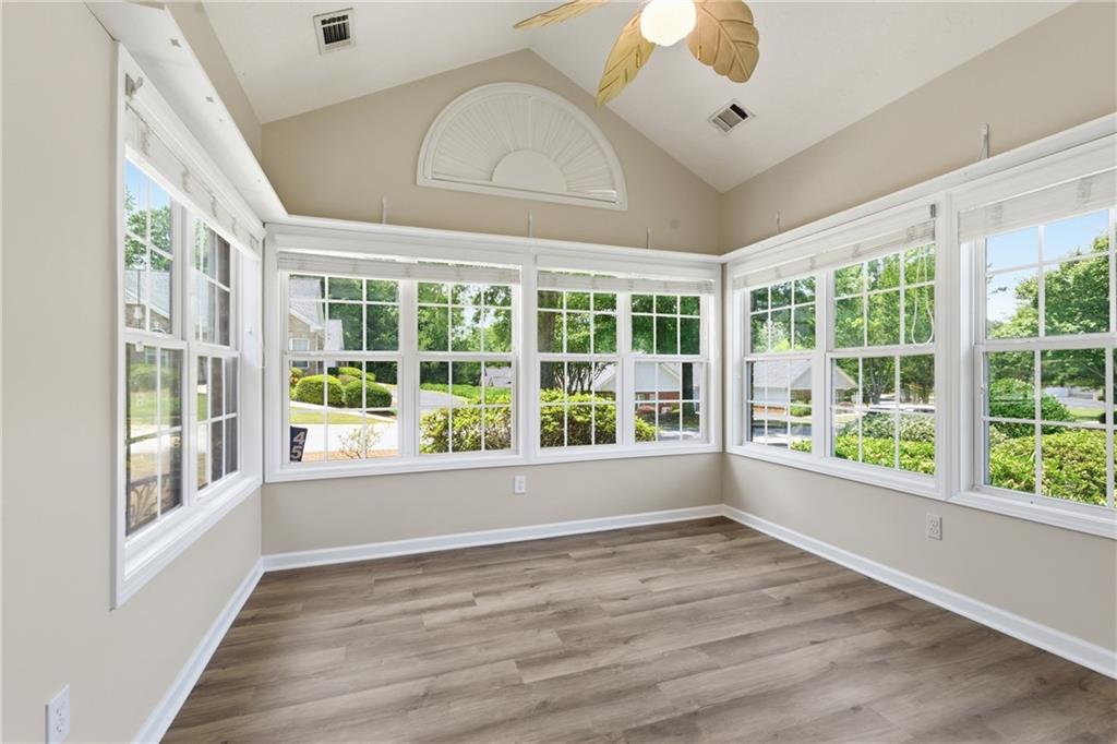 4533 Caleb Crossing, Unit 18 Powder Springs, GA 30127 - Photo 11 of 24 a view of an empty room with a window and wooden floor