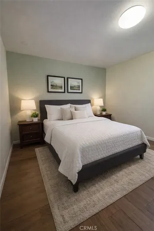 a bedroom with a bed and lamp