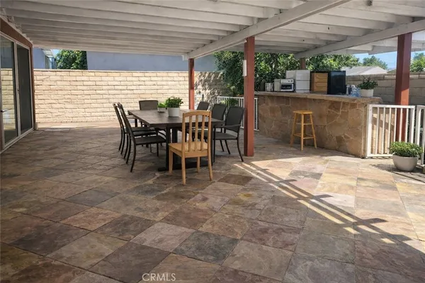 a view of a patio with table and chairs potted plants with wooden floor