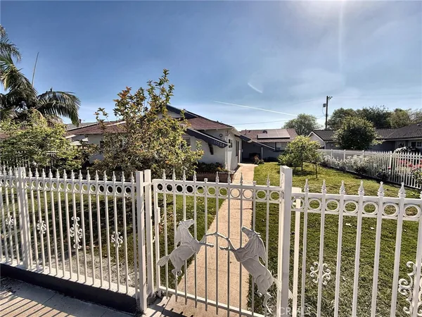 a view of a house with wooden fence