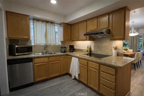 a kitchen with sink cabinets and wooden floor