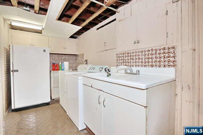 22-09 Arcadia Road Fair Lawn, NJ 07410 - Photo 20 of 28 a utility room with dryer and washer