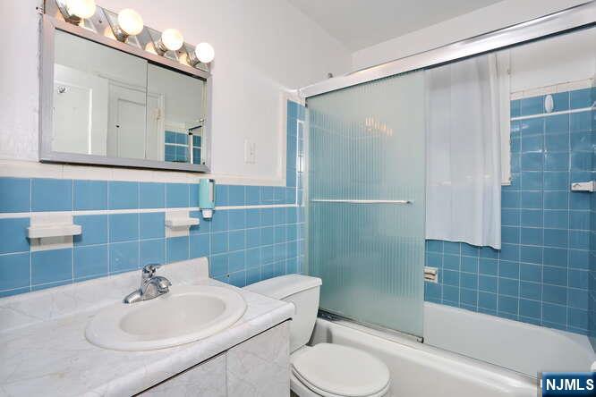 22-09 Arcadia Road Fair Lawn, NJ 07410 - Photo 6 of 28 a bathroom with a sink toilet and shower