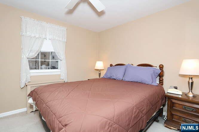 22-09 Arcadia Road Fair Lawn, NJ 07410 - Photo 8 of 28 a large bed sitting in a bedroom next to a window
