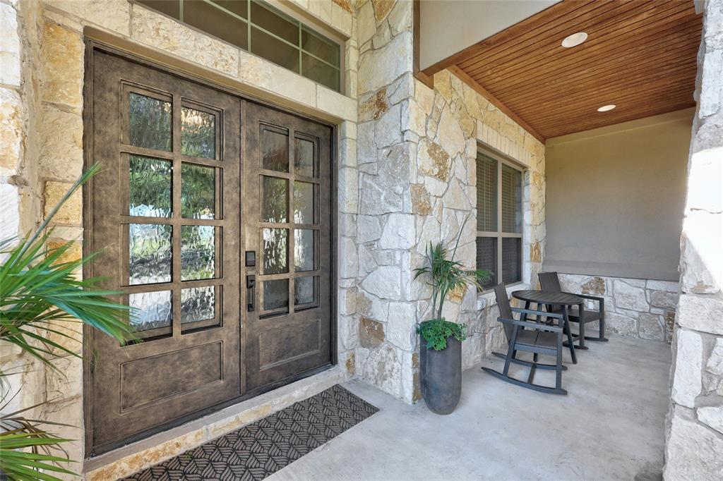 101 Aldea Street Georgetown, TX 78633 - Photo 3 of 40 Enjoy the custom details such as the tongue & groove ceiling in this covered front patio with custom metal french doors.