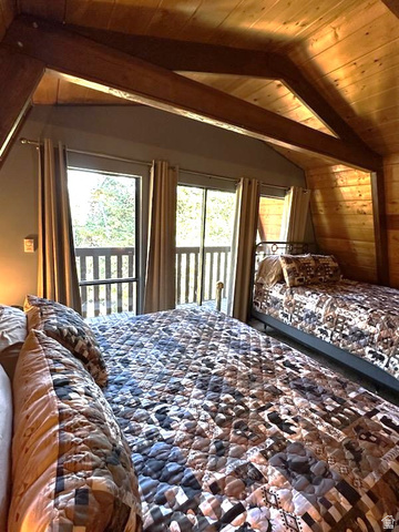 1456 Navajo Road Coalville, UT 84017 - Photo 29 of 55 Bedroom with access to exterior, a wood ceiling with exposed beams, multiple windows, and wood walls