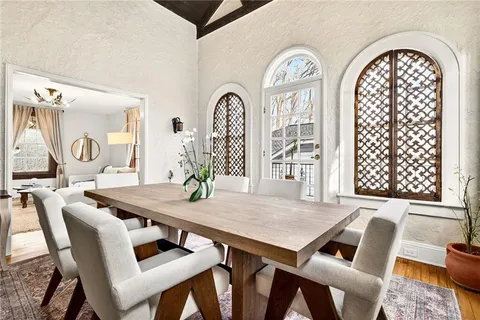 a living room with furniture a table and a large window