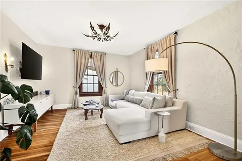 a kitchen with granite countertop white cabinets and stainless steel appliances