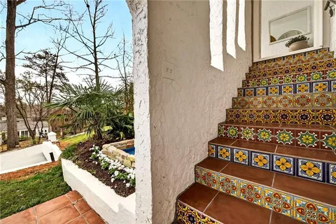 a living room with furniture and a large mirror