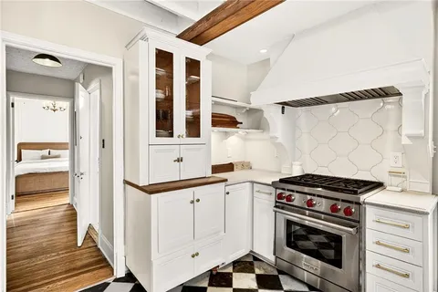 a bedroom with a large bed and a book shelf