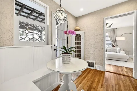a view of entryway dining room and hall with wooden floor