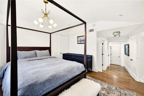 a bedroom with a large bed and a couch